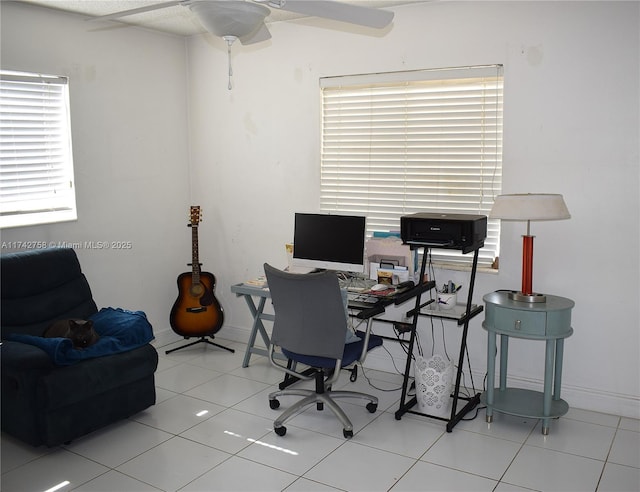 tiled office space with baseboards and ceiling fan