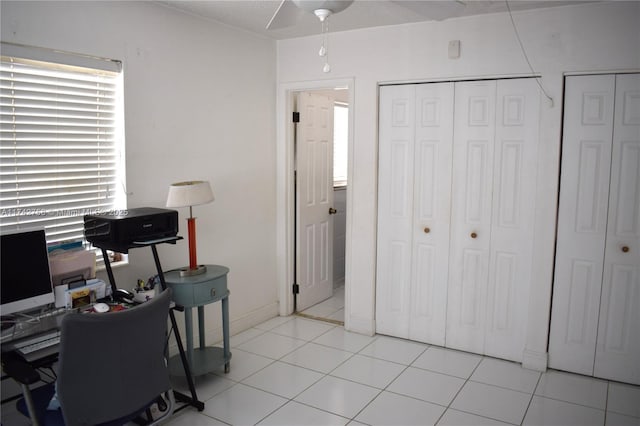 office area with light tile patterned floors and a ceiling fan