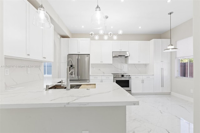 kitchen featuring stainless steel appliances, hanging light fixtures, white cabinets, and light stone counters