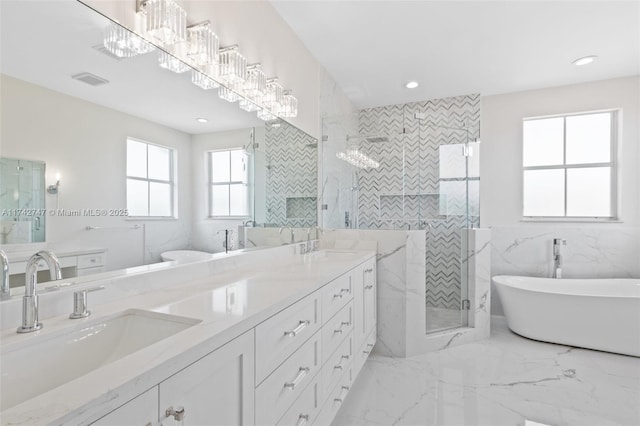 bathroom featuring vanity, shower with separate bathtub, and tile walls