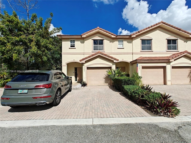 mediterranean / spanish home featuring a garage