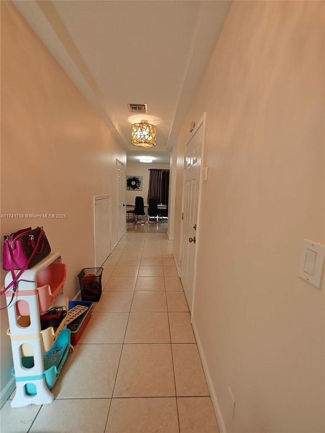 hallway with light tile patterned floors