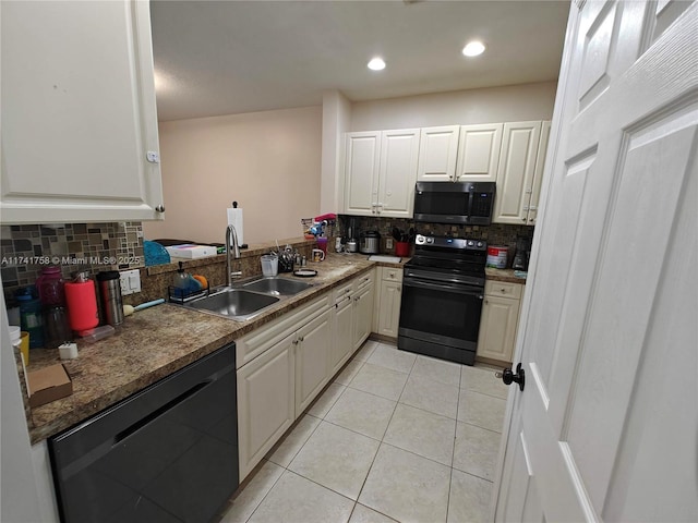 kitchen featuring sink, tasteful backsplash, black appliances, light tile patterned floors, and white cabinets