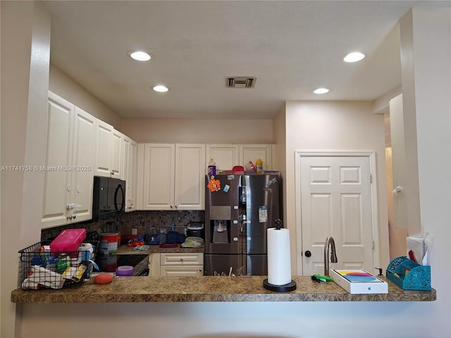 kitchen featuring white cabinetry, range with electric cooktop, stainless steel refrigerator with ice dispenser, tasteful backsplash, and kitchen peninsula