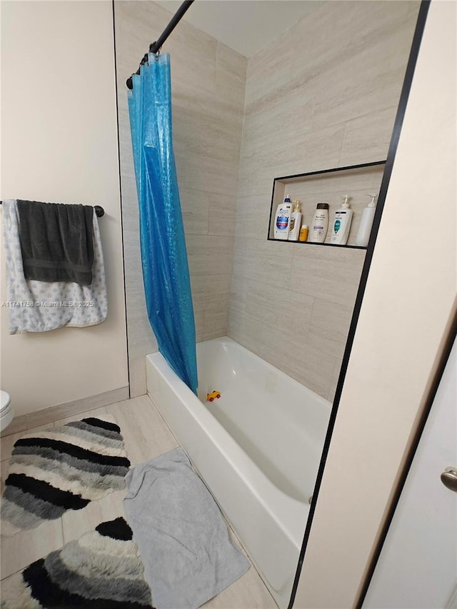 bathroom with toilet and shower / tub combo