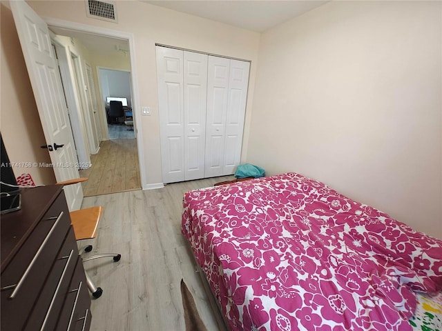 bedroom featuring light hardwood / wood-style flooring and a closet