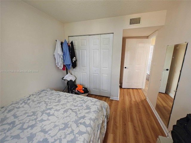 bedroom featuring light wood-type flooring and a closet