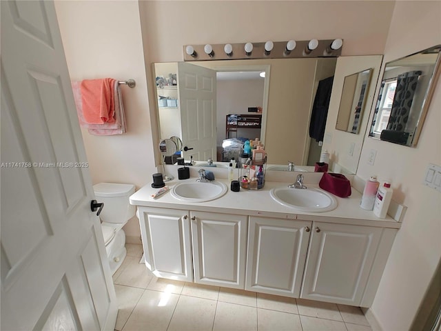 bathroom featuring vanity, tile patterned flooring, and toilet