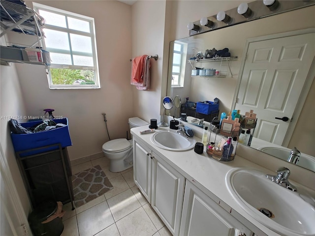 bathroom featuring vanity, toilet, and tile patterned flooring