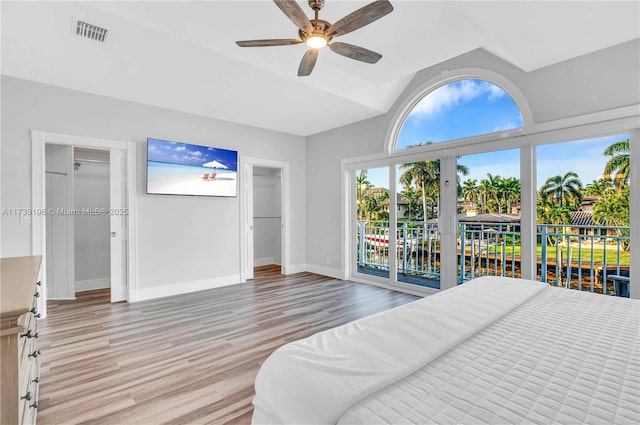 bedroom with lofted ceiling, hardwood / wood-style floors, access to exterior, and ceiling fan