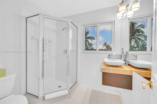 bathroom featuring an enclosed shower, vanity, tile patterned flooring, and toilet