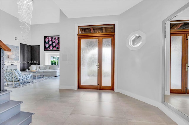 foyer entrance with french doors and an inviting chandelier