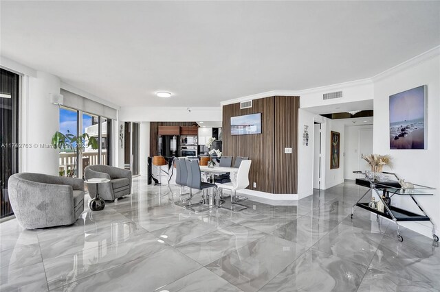 living room with wooden walls and ornamental molding