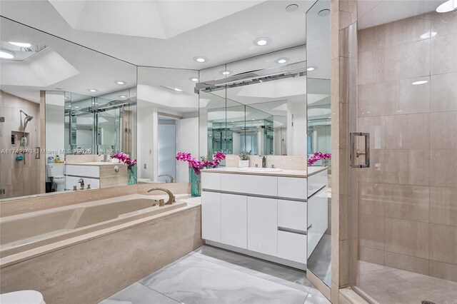 bathroom with vanity and separate shower and tub