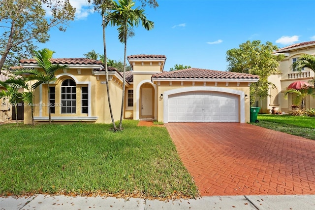 mediterranean / spanish-style house featuring a garage and a front lawn