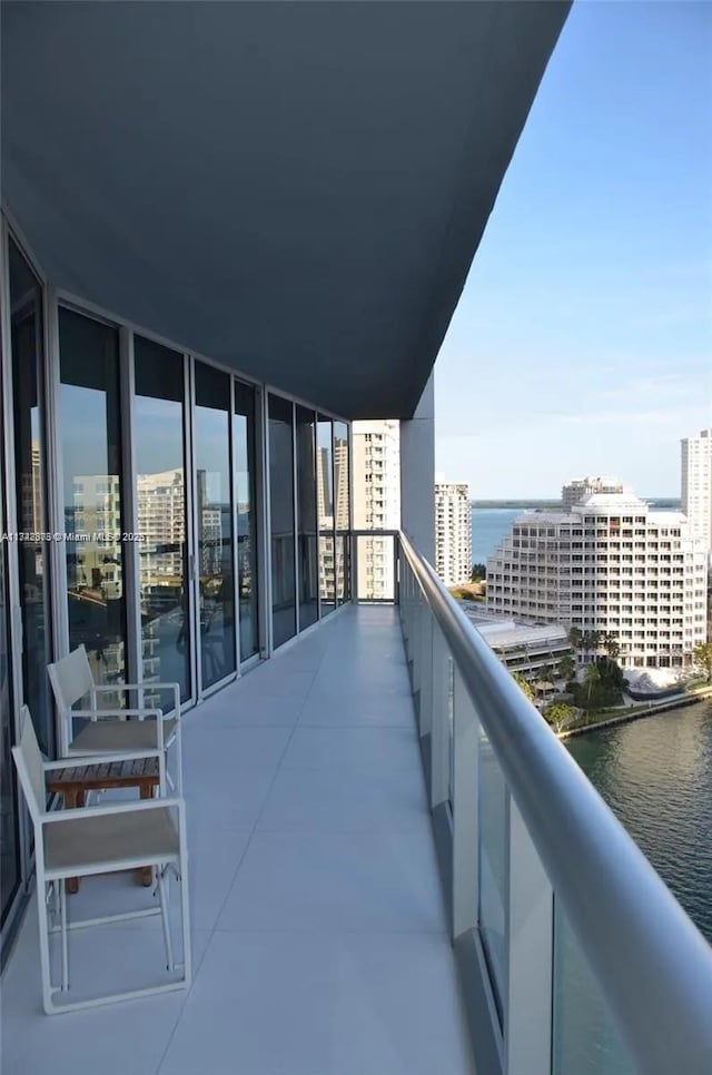 balcony featuring a water view and a view of city