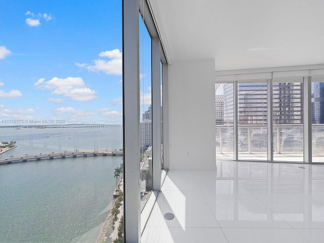 unfurnished sunroom featuring a water view