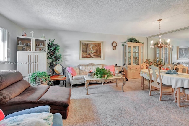 living room featuring a notable chandelier, carpet floors, and a textured ceiling