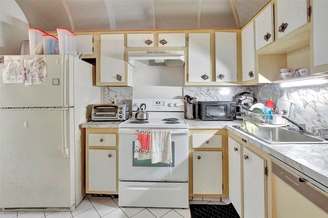 kitchen featuring white appliances, sink, decorative backsplash, and light tile patterned floors