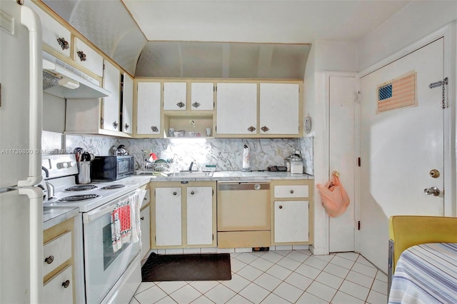 kitchen featuring light tile patterned flooring, white appliances, sink, and backsplash