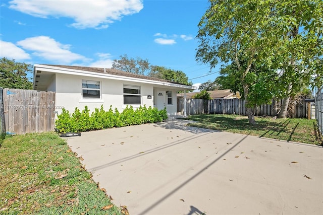 view of front of house featuring a front lawn and a patio