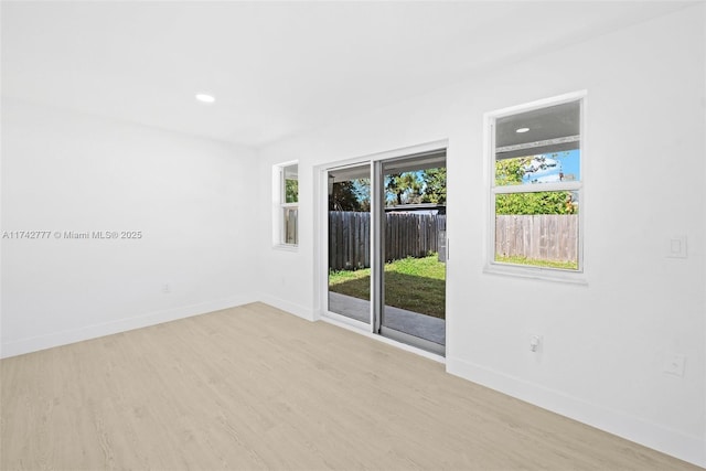 unfurnished room with light wood-type flooring