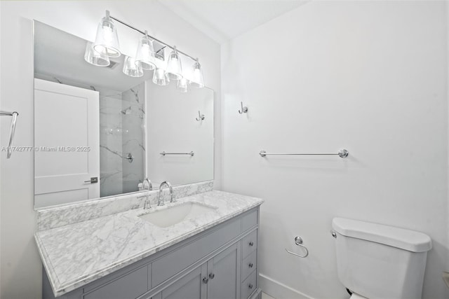 bathroom with vanity, a shower with door, and toilet