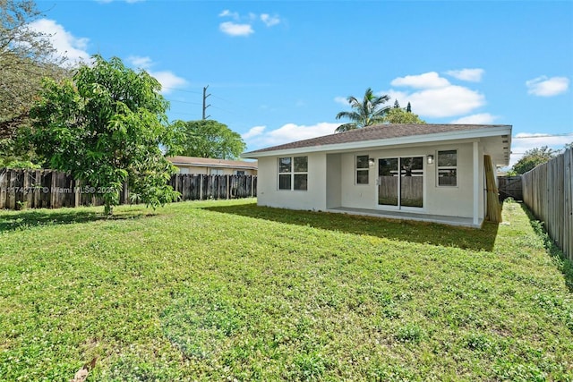 rear view of house with a lawn