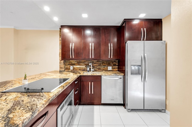 kitchen featuring light stone counters, crown molding, tasteful backsplash, appliances with stainless steel finishes, and kitchen peninsula