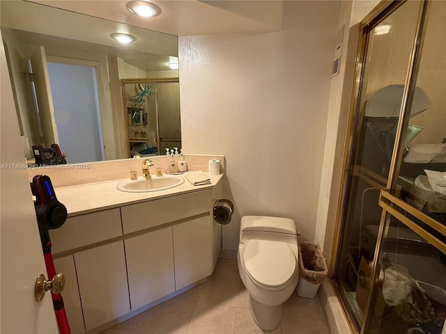 bathroom featuring vanity, an enclosed shower, tile patterned floors, and toilet