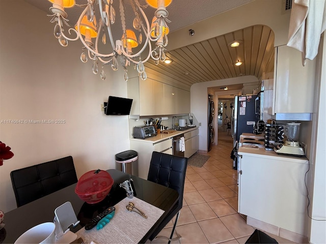 tiled dining space with an inviting chandelier