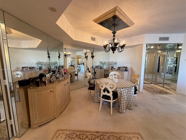 dining area featuring a raised ceiling, light carpet, a textured ceiling, and an inviting chandelier