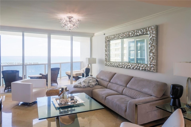 living room with a water view, ornamental molding, an inviting chandelier, and expansive windows