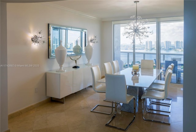 dining space featuring crown molding, a water view, and an inviting chandelier