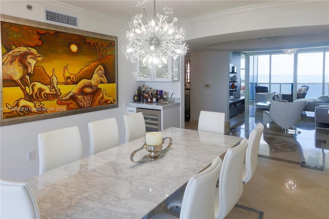 dining room featuring ornamental molding, a water view, indoor bar, and a chandelier