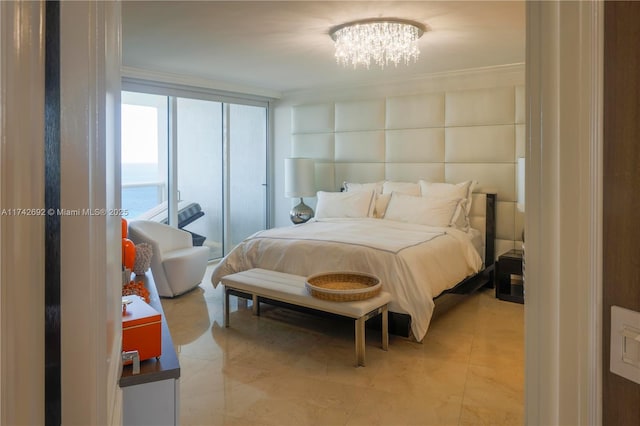 bedroom featuring a chandelier and a wall of windows