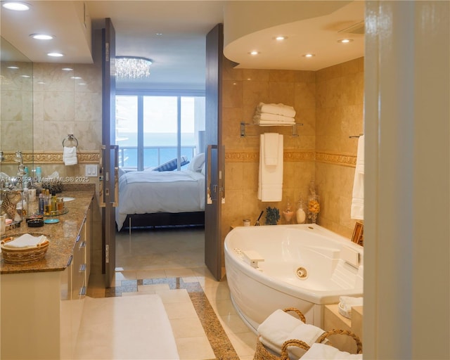 bathroom with vanity, tile walls, and a washtub