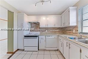 kitchen featuring light tile patterned flooring, white cabinetry, range, dishwasher, and backsplash