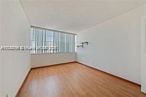 spare room featuring wood-type flooring