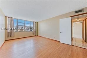 unfurnished room with hardwood / wood-style flooring