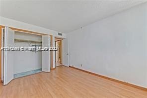 unfurnished bedroom featuring light wood-type flooring