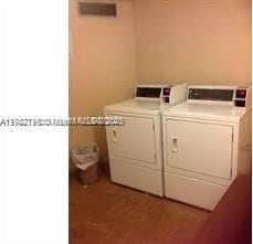 washroom featuring washing machine and clothes dryer