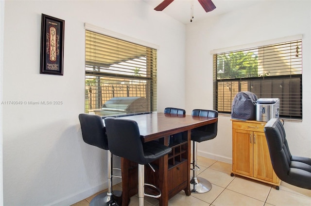 tiled office space featuring ceiling fan and a healthy amount of sunlight