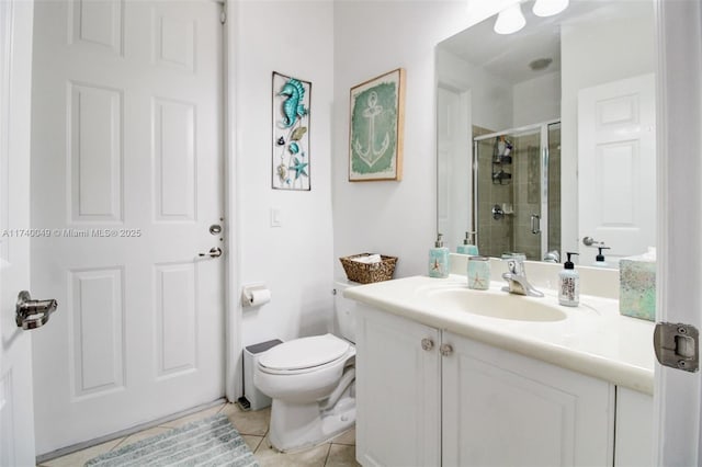 bathroom featuring an enclosed shower, vanity, tile patterned floors, and toilet