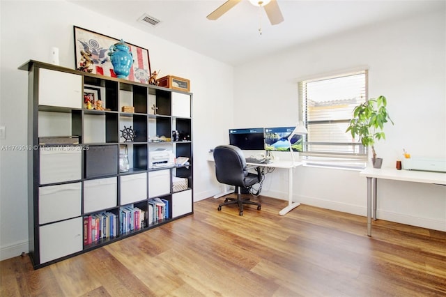 home office featuring hardwood / wood-style flooring and ceiling fan