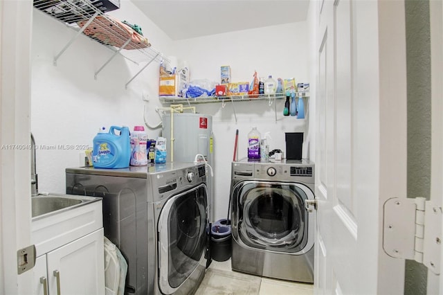 laundry area featuring cabinets, light tile patterned flooring, separate washer and dryer, and water heater