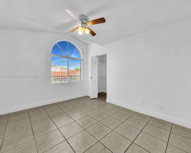 empty room with a textured ceiling and ceiling fan