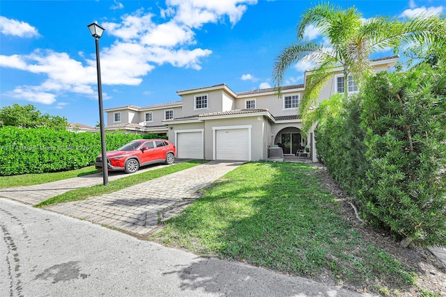 view of front of home featuring a garage and a front yard