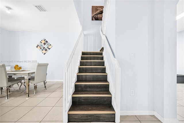 stairs with tile patterned floors