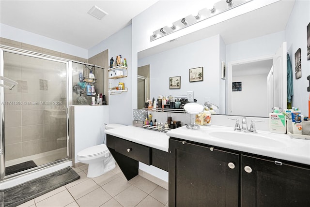 bathroom with vanity, a shower with shower door, tile patterned floors, and toilet